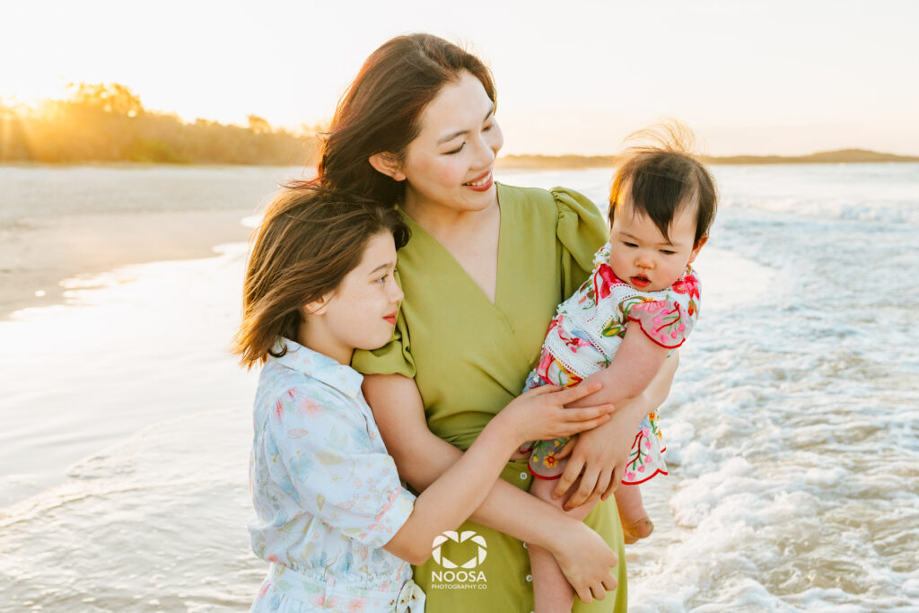 Noosa family photographer capturing a loving families on the beach at golden hour