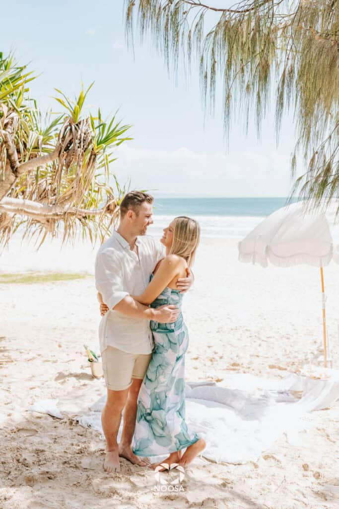 Couple embrace Noosa Main Beach