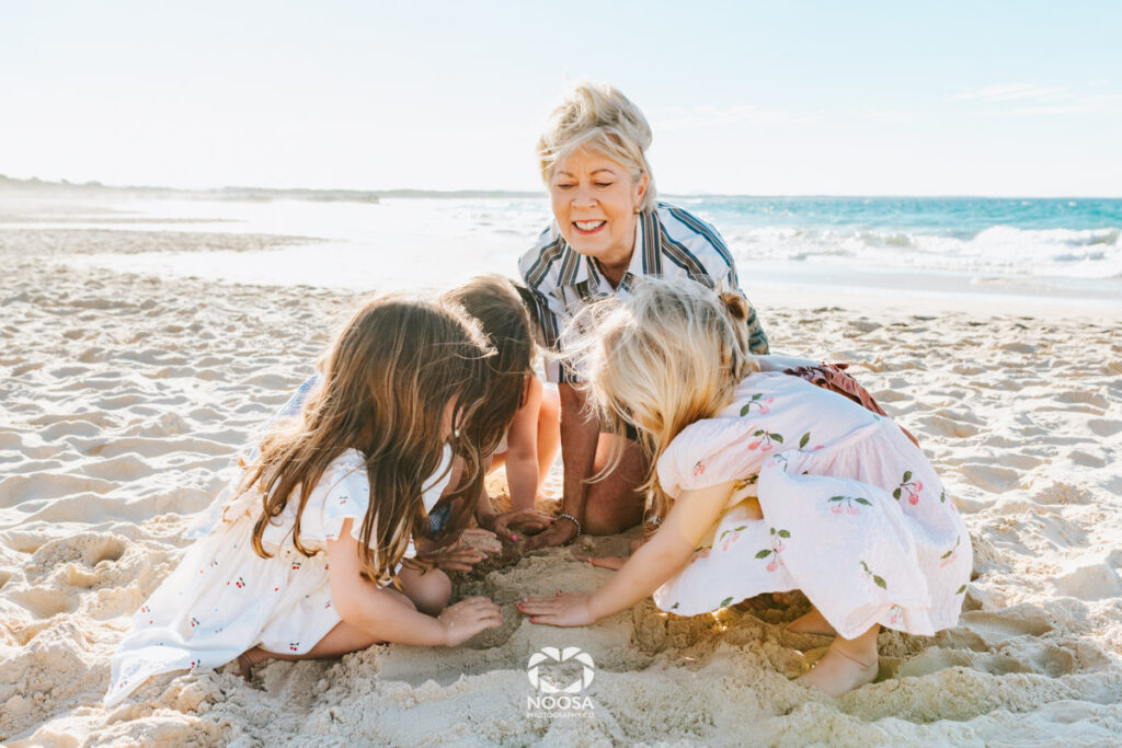 Grandma and her granddaughters on the beach Noosa