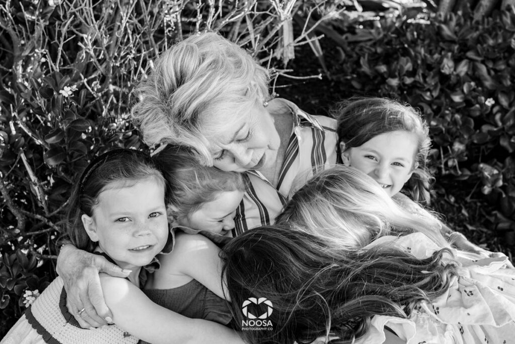 Grandma and her granddaughters hug in Noosa